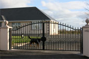 Wrought iron entrance gate with arched top.