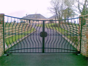Shaped wrought iron gates with convex top.